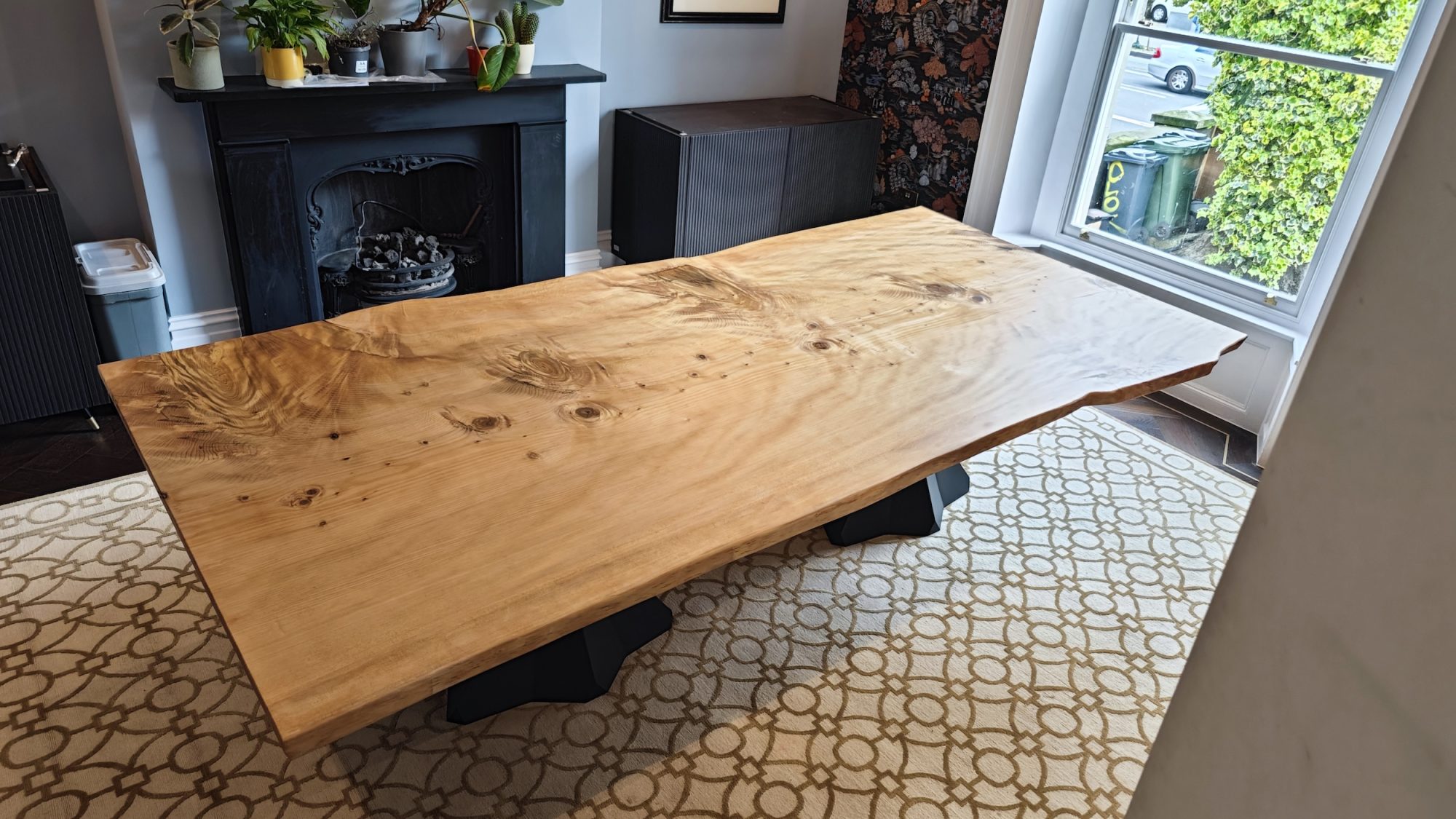 Cedar of Lebanon dining table by a fireplace