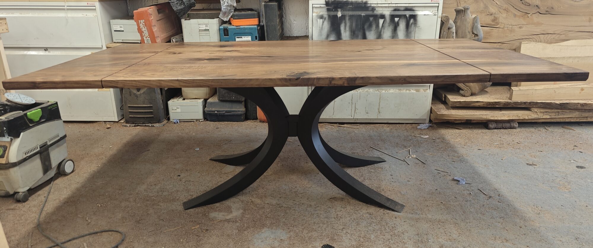 Walnut table on an arched steel base