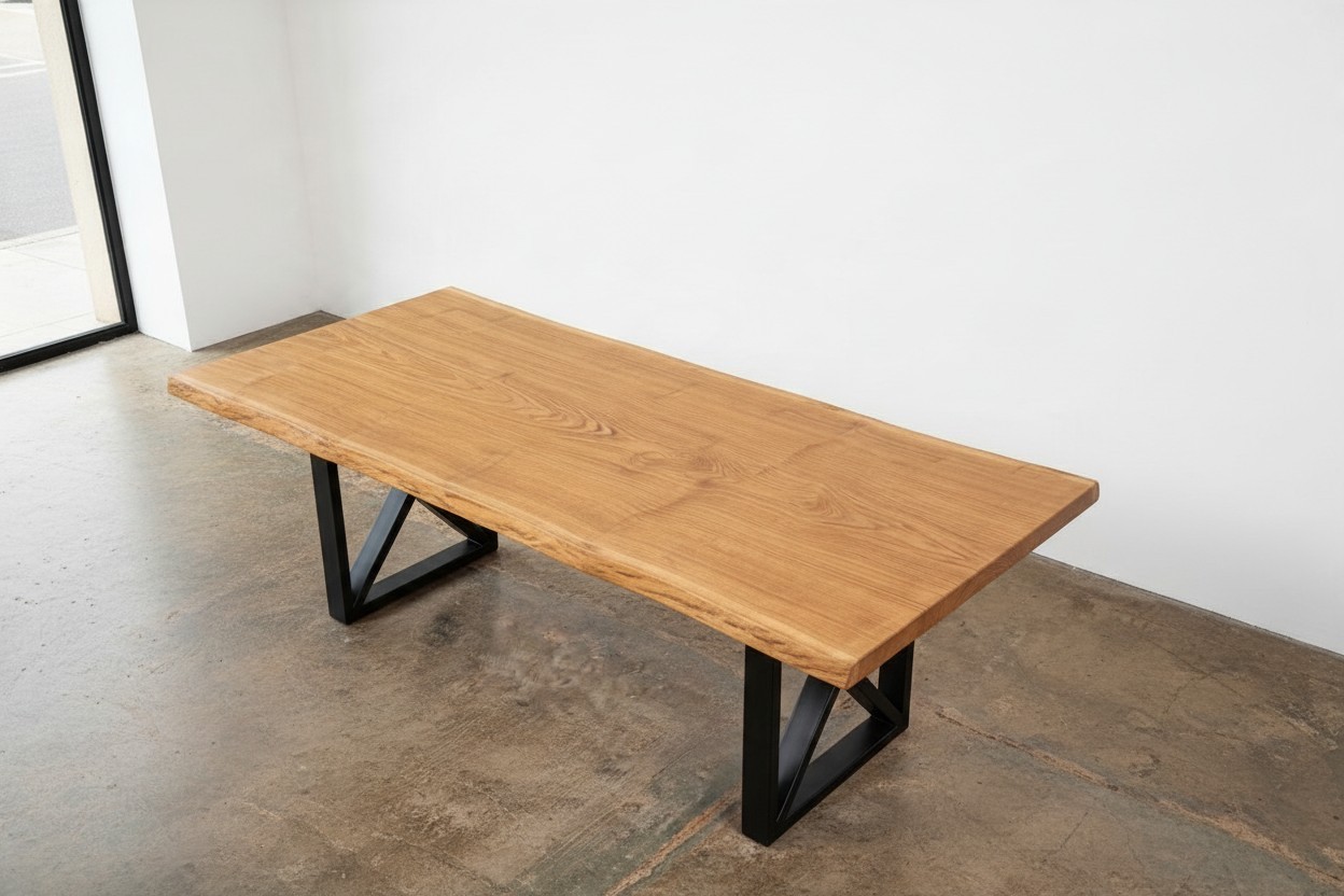Solid French Oak dining table with black steel base in a bright dining room